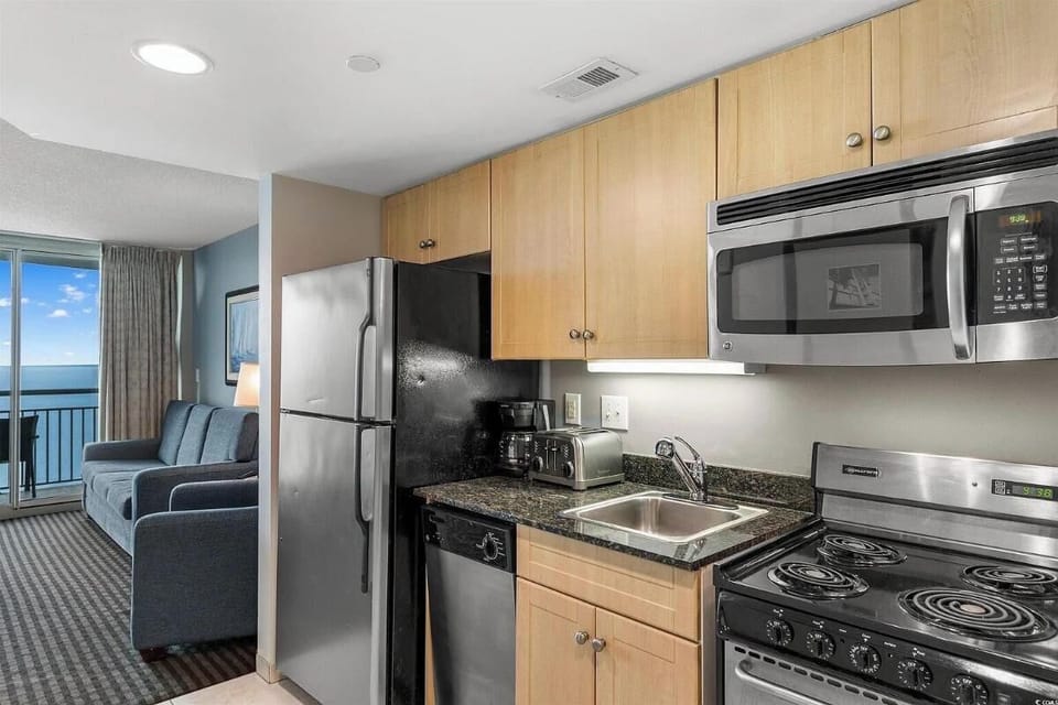 Stylish kitchen featuring stainless steel appliances, sleek granite countertops,