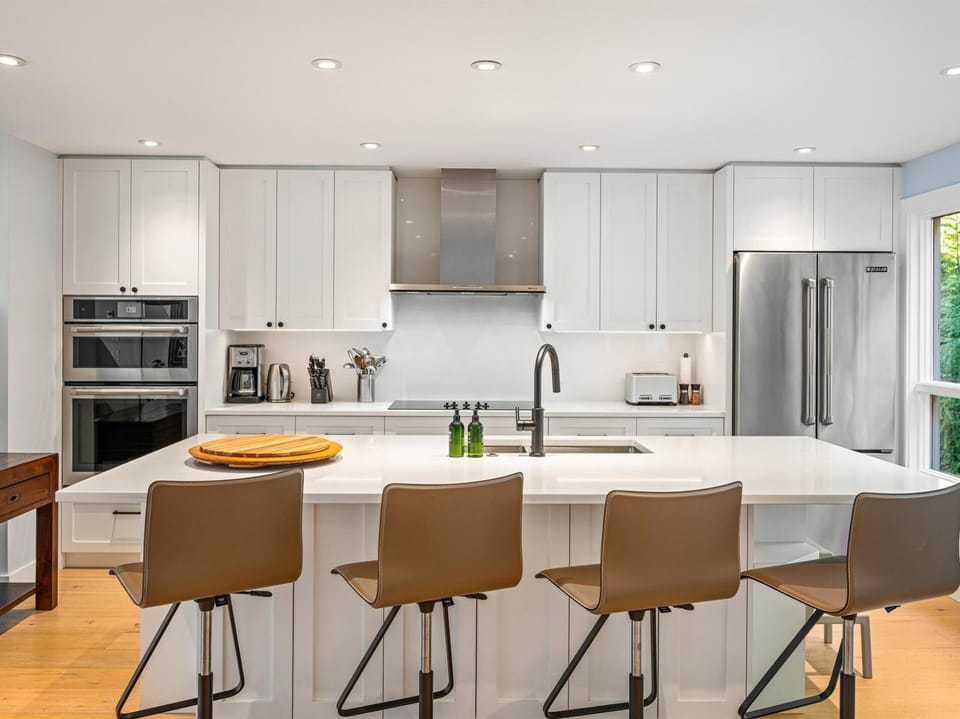 Bright and spacious kitchen with 4 seats at the island. Double oven, induction stove, dishwasher, drip coffee and fully stocked for entertaining.