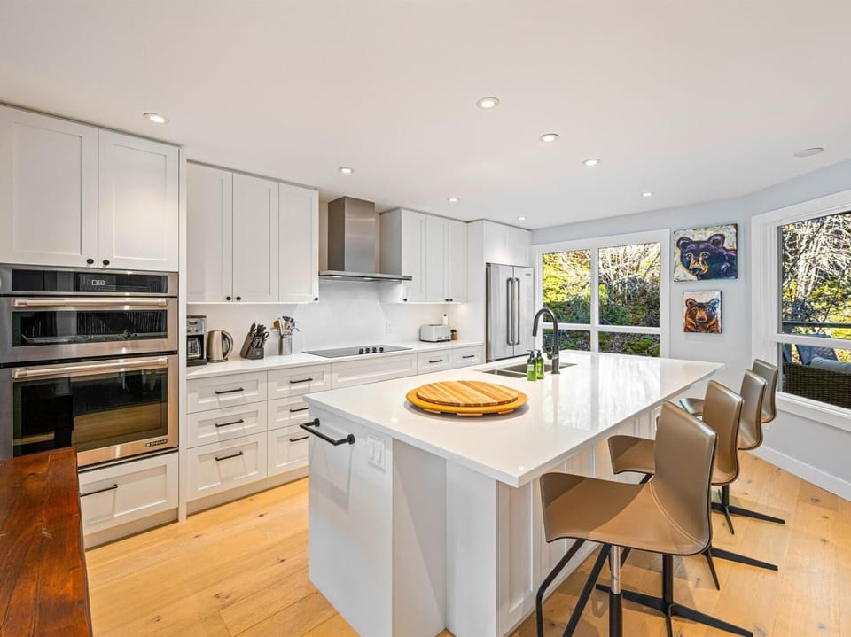 Bright and spacious kitchen with 4 seats at the island. Double oven, induction stove, dishwasher, drip coffee and fully stocked for entertaining.