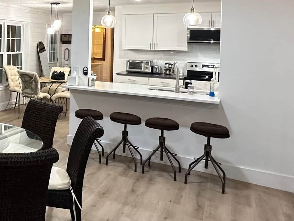 Kitchen Bar:  Four adjustable stools make a great spot for a casual bite or a chat with the cook