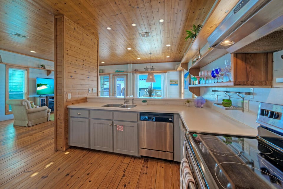 Main House: View of the kitchen layout emphasizing the ample counter space and natural light.