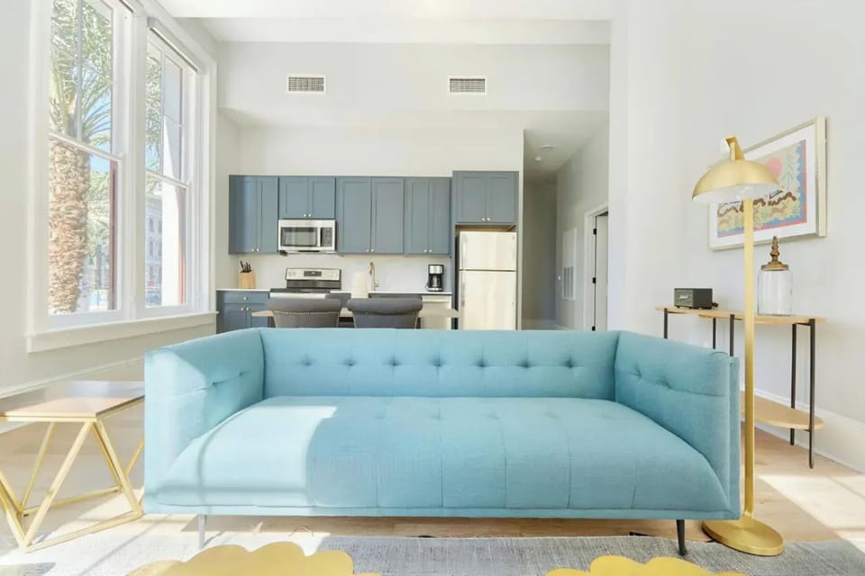 Bright and airy living room with plush seating and a TV to keep you entertained.