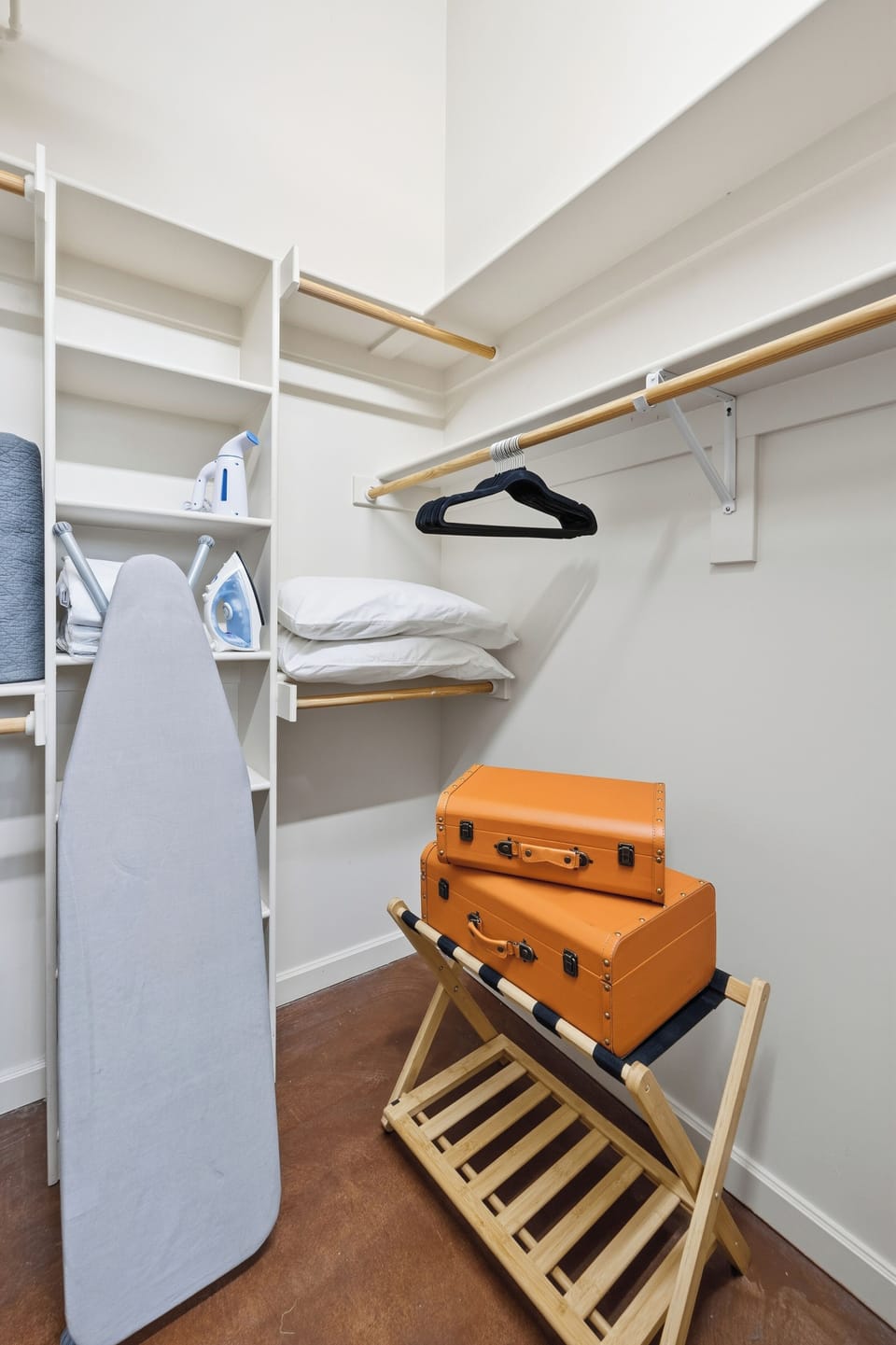 Iron, ironing board, and steamer conveniently stored in the bedroom closet.