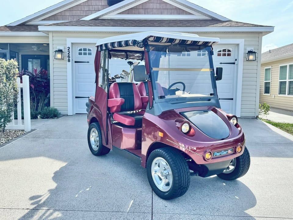 Electric 2-Seater ParCar Golf Cart w/ 2 Sets of Golf Clubs Provided - Adjustable Seats, Full Enclosure, Front Storage & 50 Miles on a Full Charge