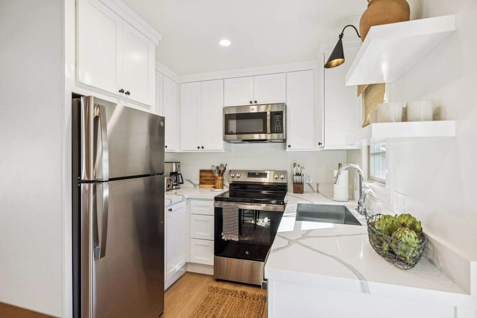 Full kitchen: Coffee drip, fridge, stove/oven, plates and utensils, dishwasher