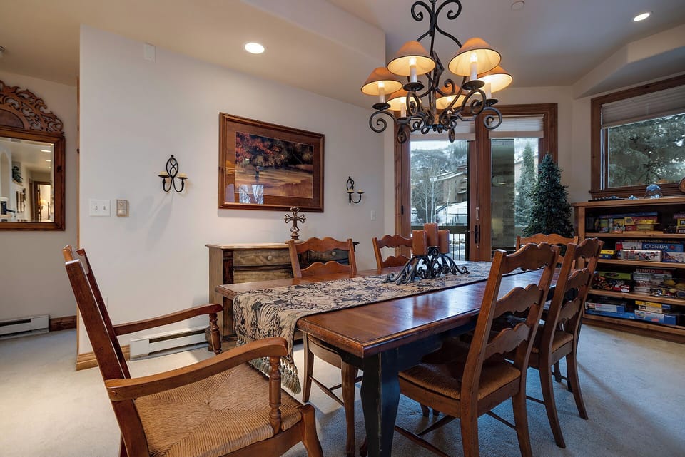 Gather around this elegant dining table where memorable meals and conversations unfold beneath warm chandelier light.