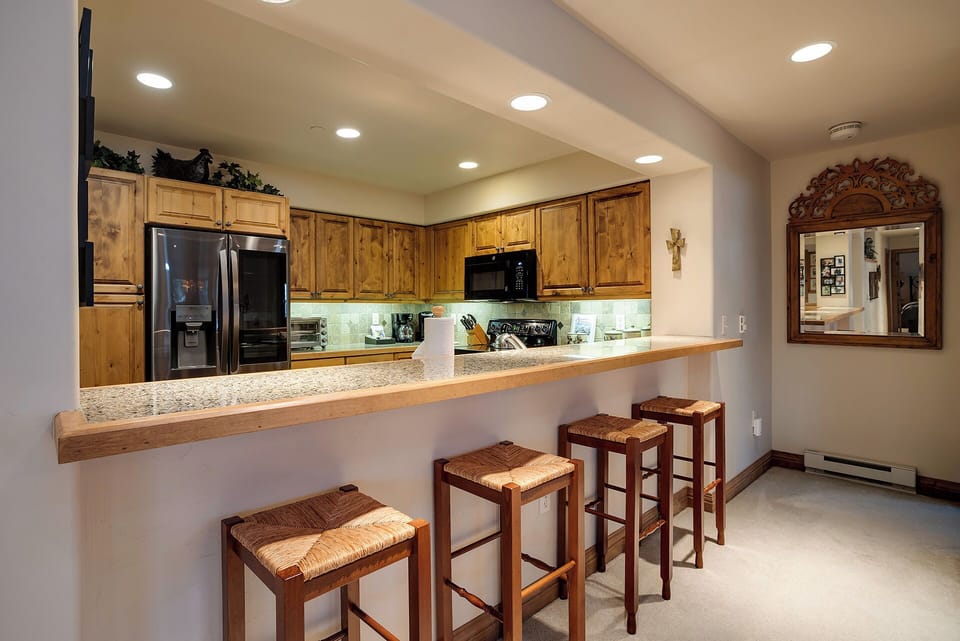 Gather around your spacious granite breakfast bar with rustic charm and modern convenience at your fingertips.
