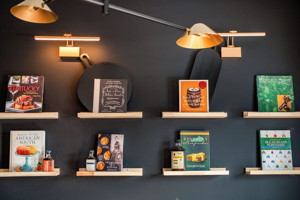 Curated bourbon & Kentucky cookbook wall celebrating local flavor and heritage