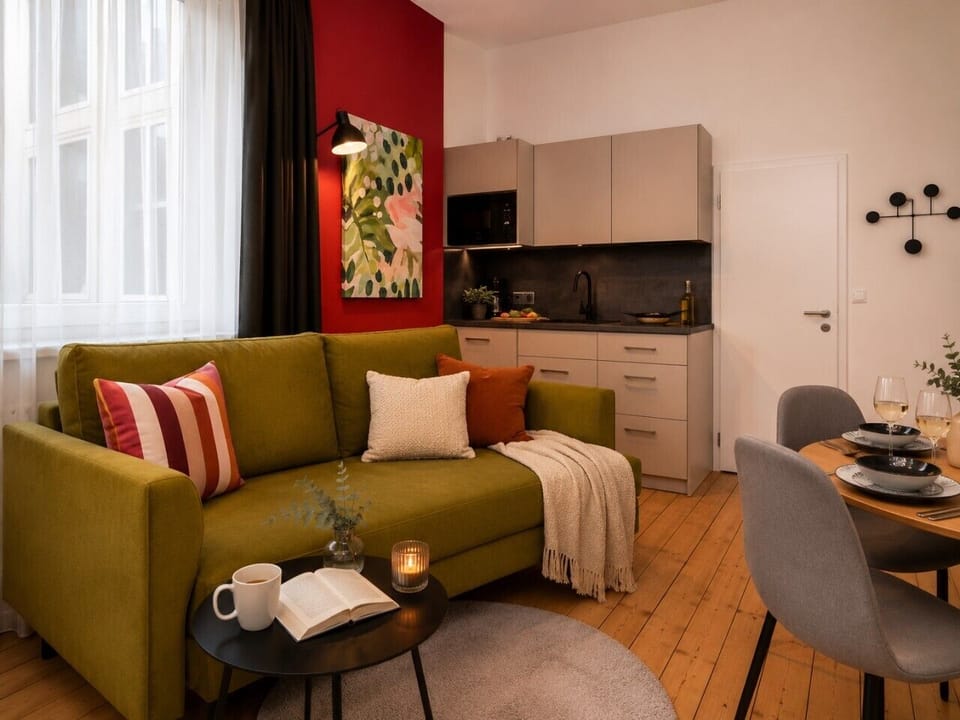 Enjoy the comfort of this inviting studio with a cozy sofa, functional kitchenette, dining area, and contemporary furnishings that create a welcoming home-away-from-home atmosphere.