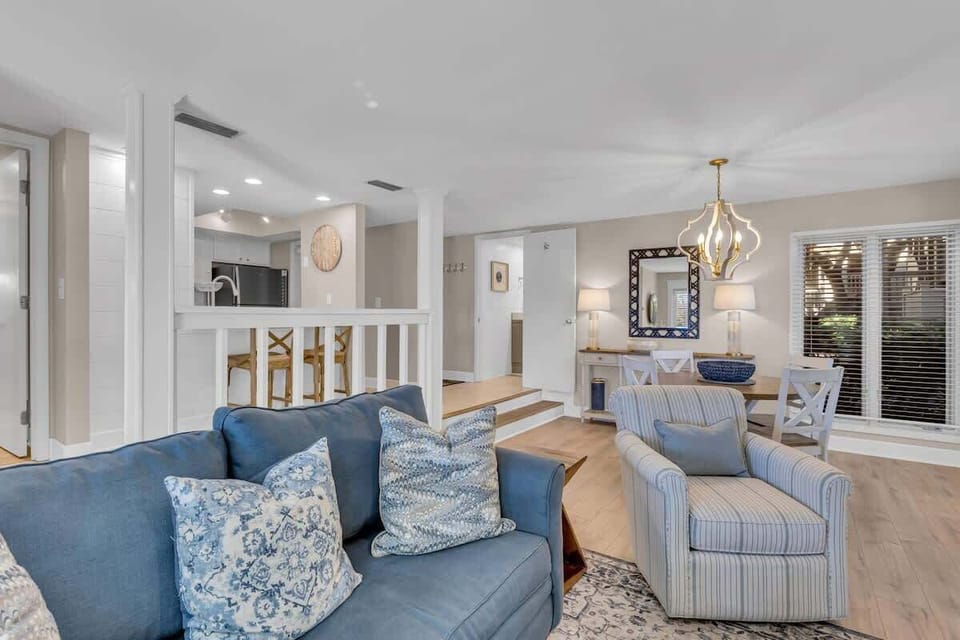 Sink into plush seating where coastal blues meet elegant neutrals, creating your perfect retreat for relaxation and connection.