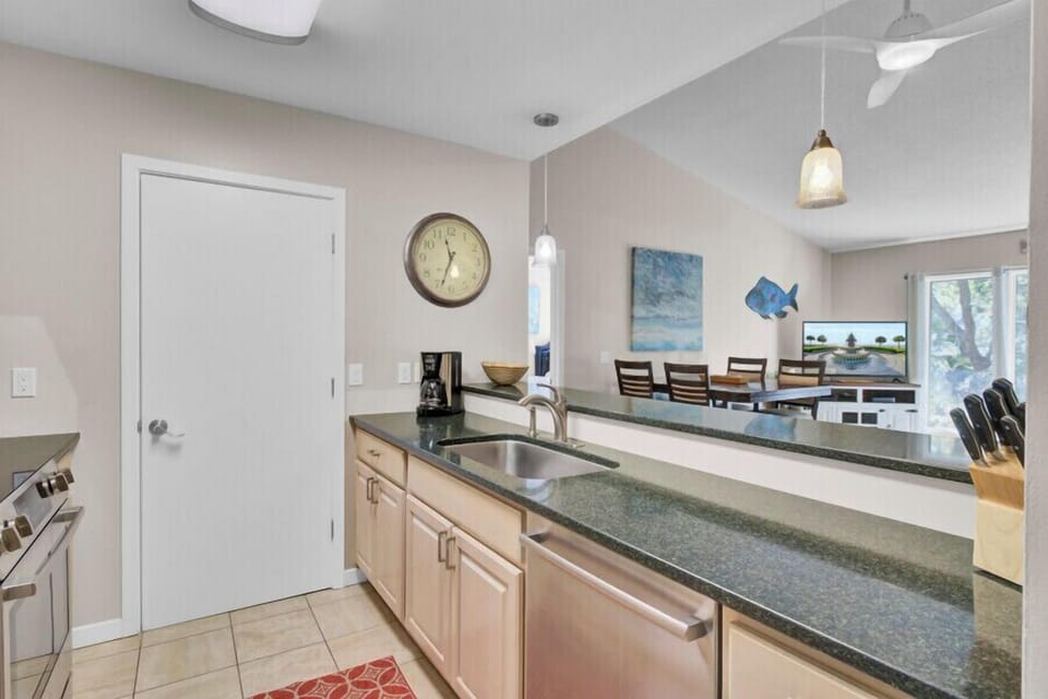 Your fully equipped kitchen features granite countertops, stainless appliances, and an open layout that flows into the dining area for memorable meals together.