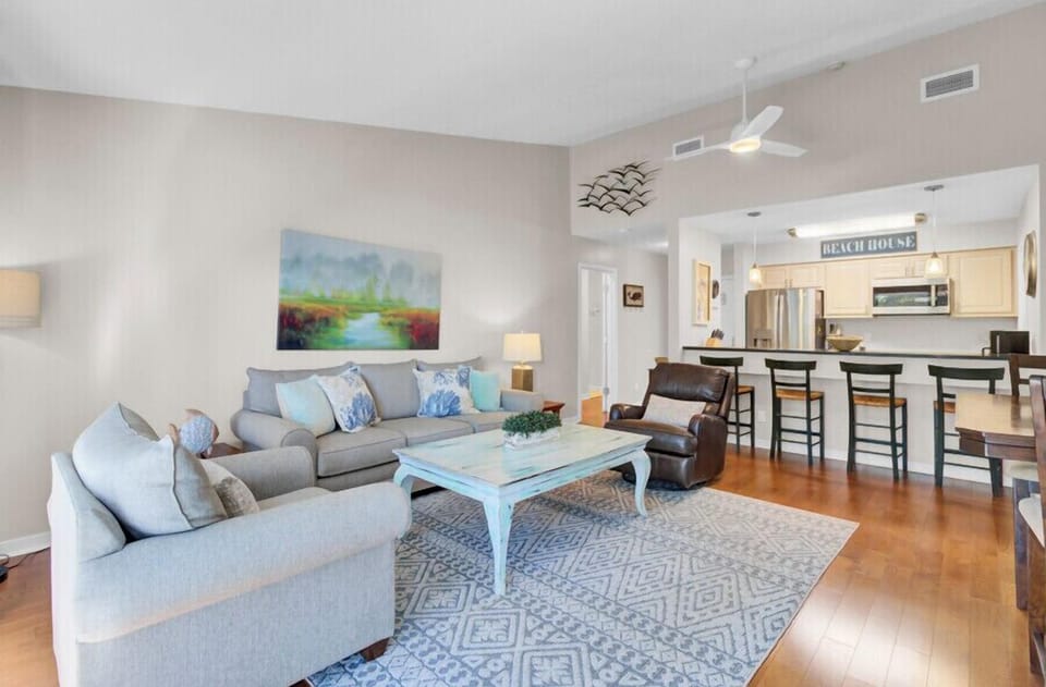 Sink into plush seating while ocean breezes flow through your bright, open living space with modern kitchen and coastal charm.