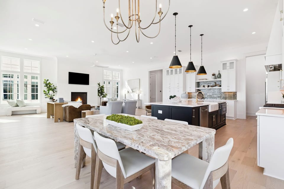 Step into your luxurious open-concept living space where marble dining table meets gourmet kitchen—perfect for memorable gatherings.