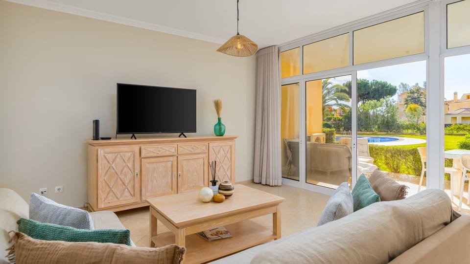 Bright and spacious living room with direct pool views and access to a private outdoor lounge.
#LivingRoomView #VilamouraEscape #PoolView #AirConditioned #LovelyStay