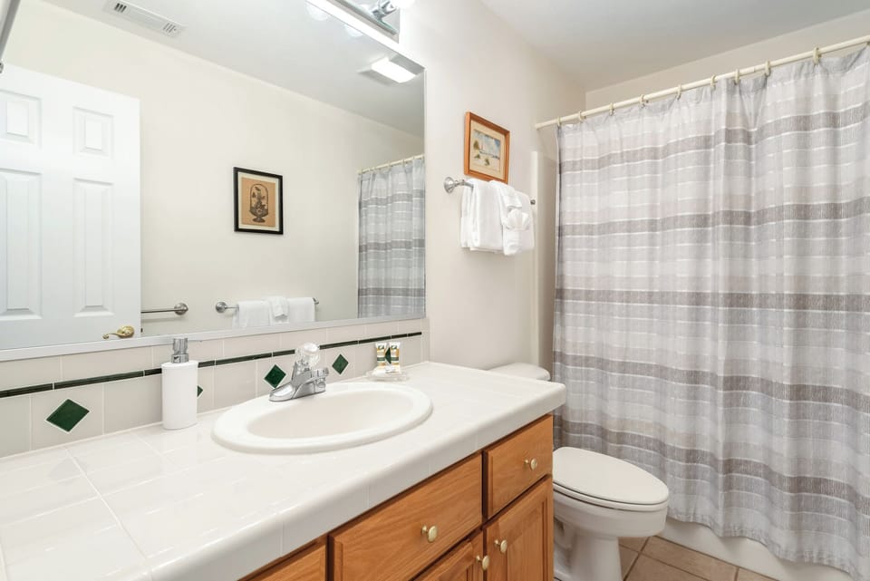 Upstairs full bathroom with clean, functional layout.
