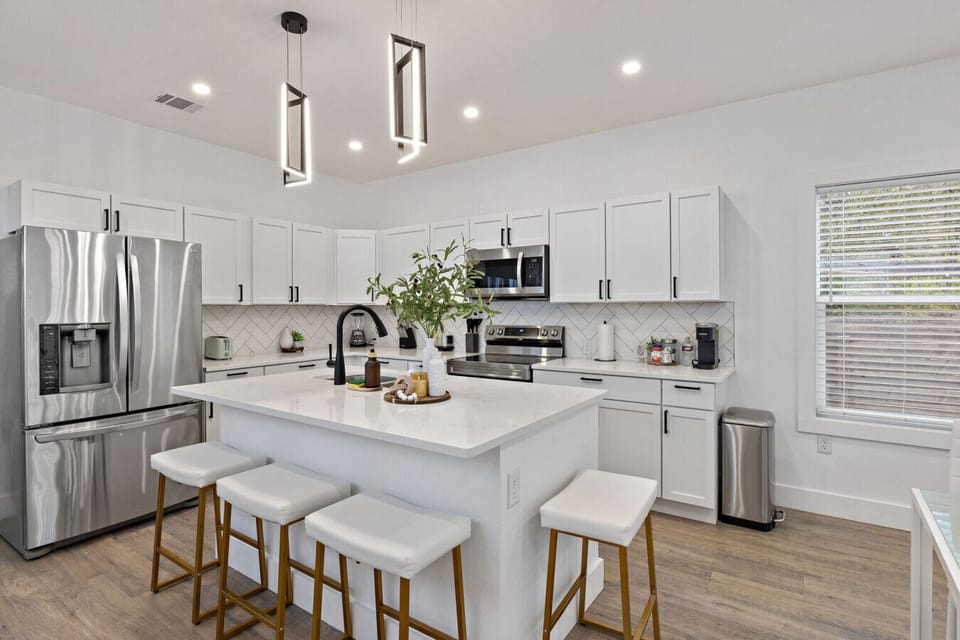 A chef-worthy kitchen with quartz island, stainless appliances, and bar seating - everything you need for home-cooked meals and slow mornings together.