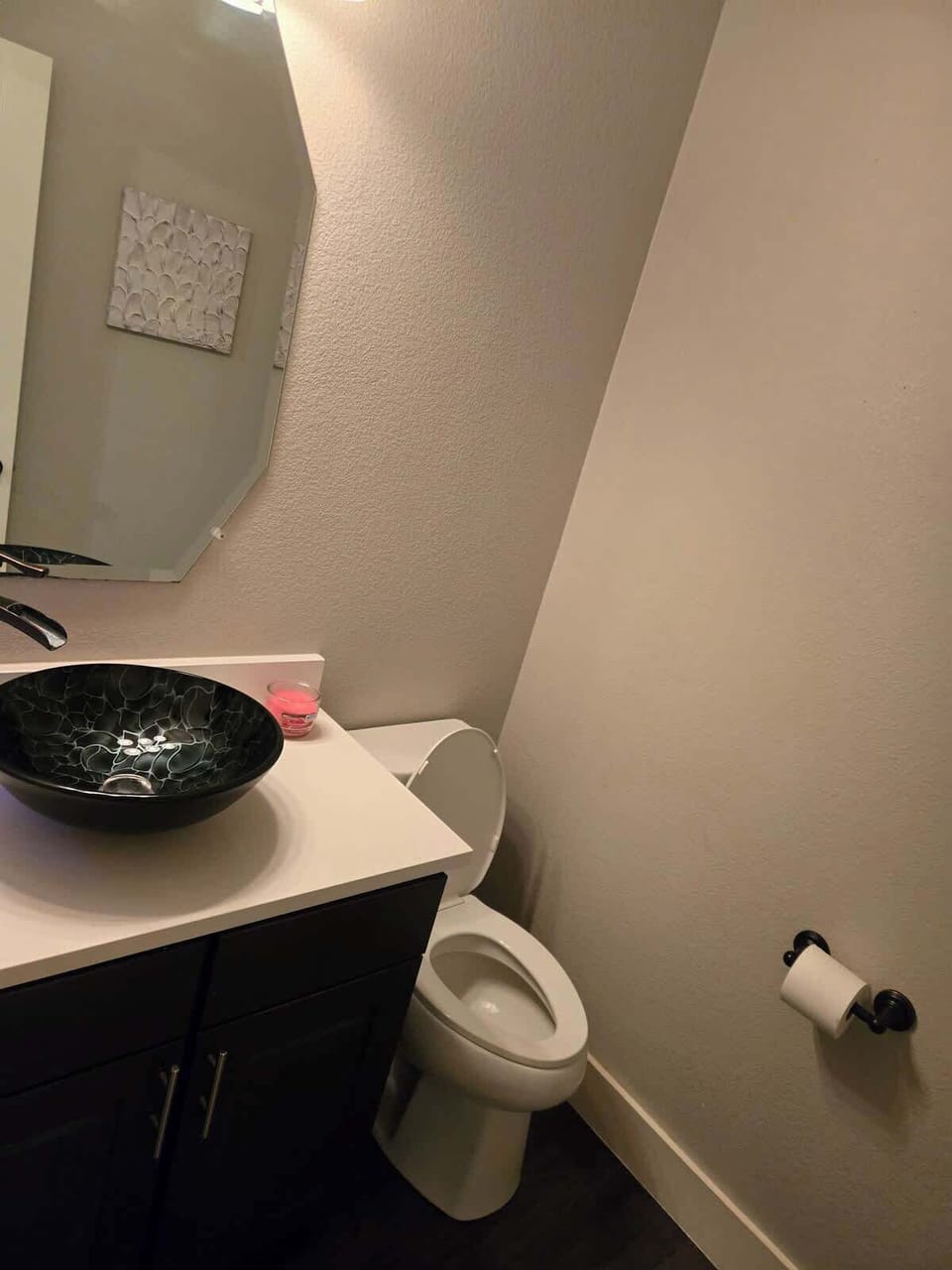 Half bathroom on 1st floor next to stairs in living-room, adjacent from movie room.
