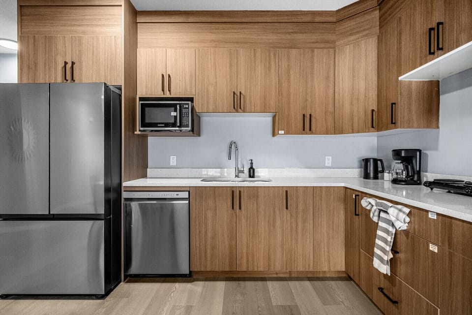 Fully equipped kitchen with stainless appliances and ample cabinet storage
