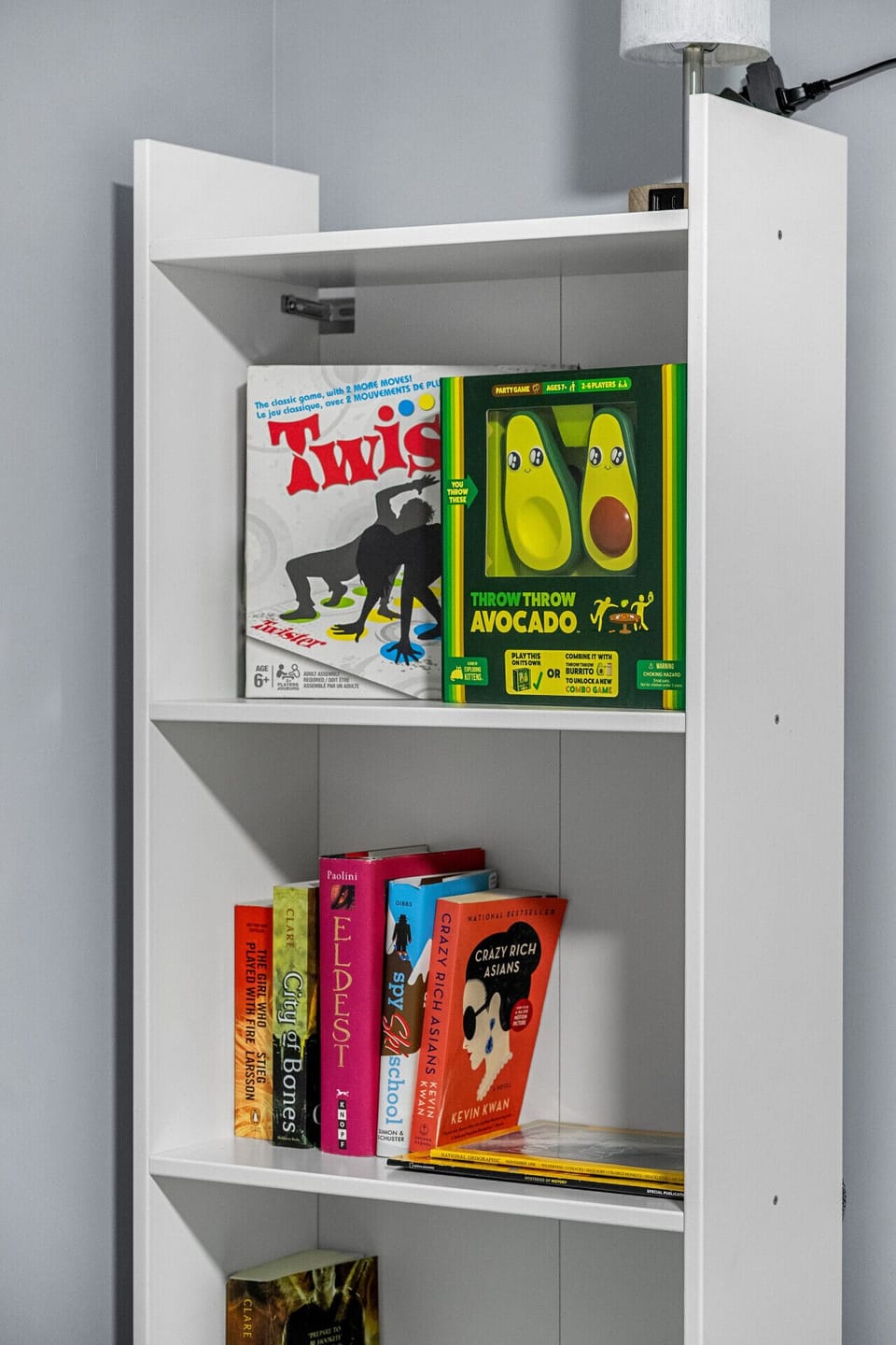 Shelf filled with board games and books for the whole family