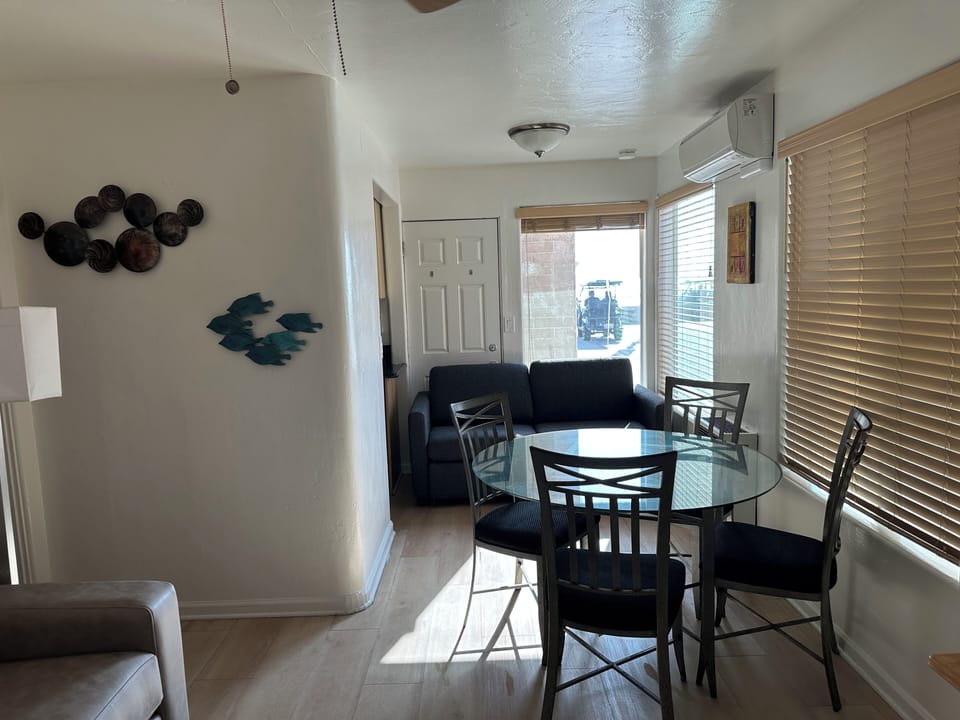 Nicely appointed living room with wood floors, two queen sleeper sofas, etc.