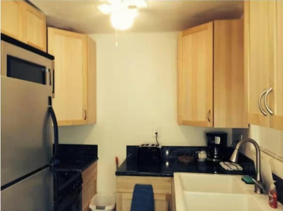 Full kitchen - stove, oven, refrigerator, microwave , dishwasher, granite, wood.
