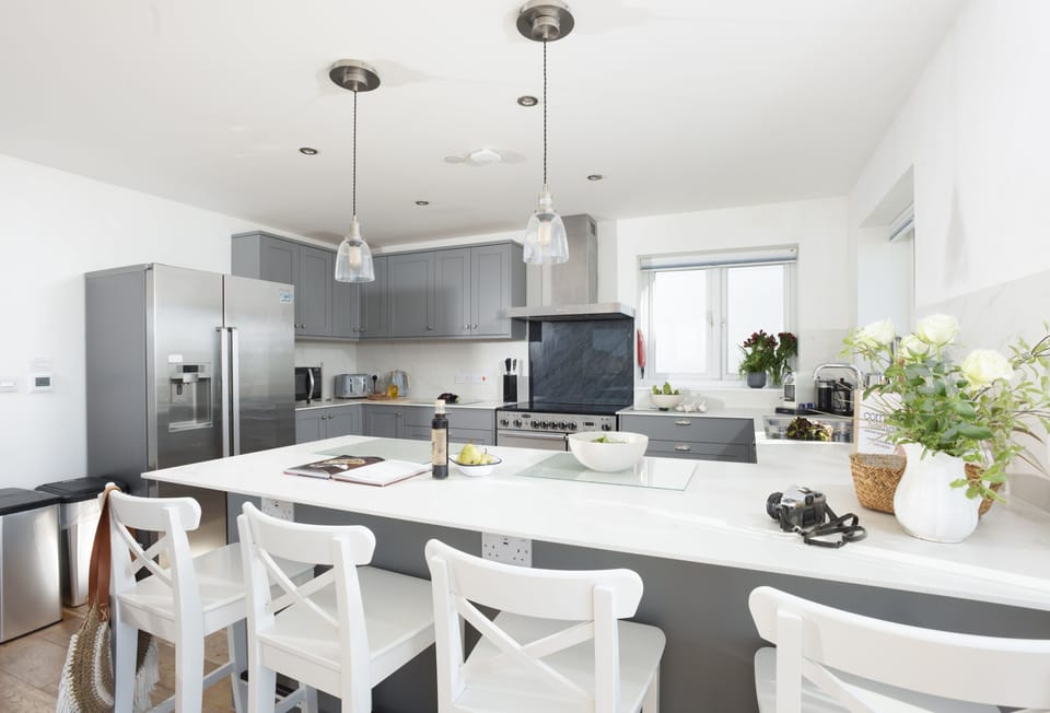 Seaside House, Portreath. Sleek and modern kitchen with American fridge freezer