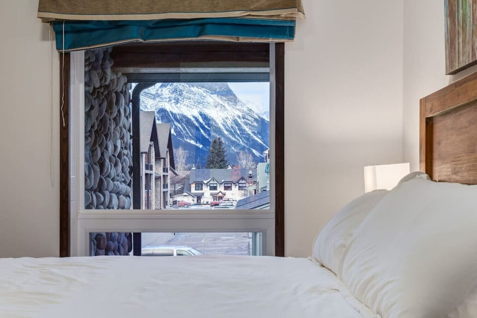 Master Bedroom with comfortable queen sized bed and mountain view