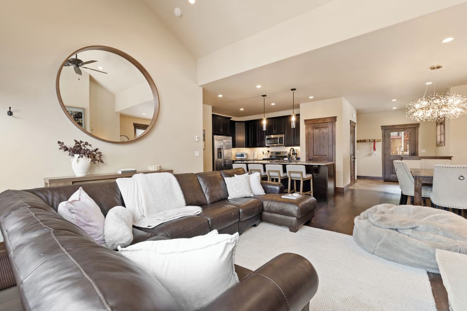 Sink into the plush leather sectional and feel at home in this open, airy living space where modern comfort meets mountain elegance, perfect for gathering with loved ones.