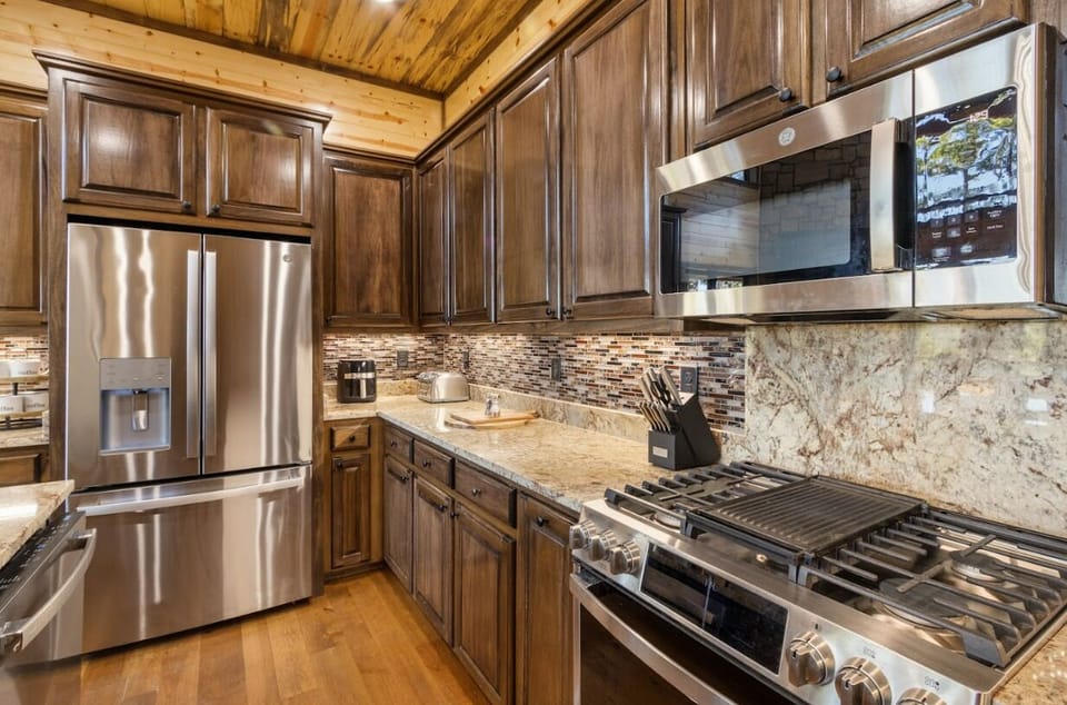 Prepare meals in style within this high-end kitchen featuring custom cabinetry, granite countertops, and premium stainless steel appliances.
