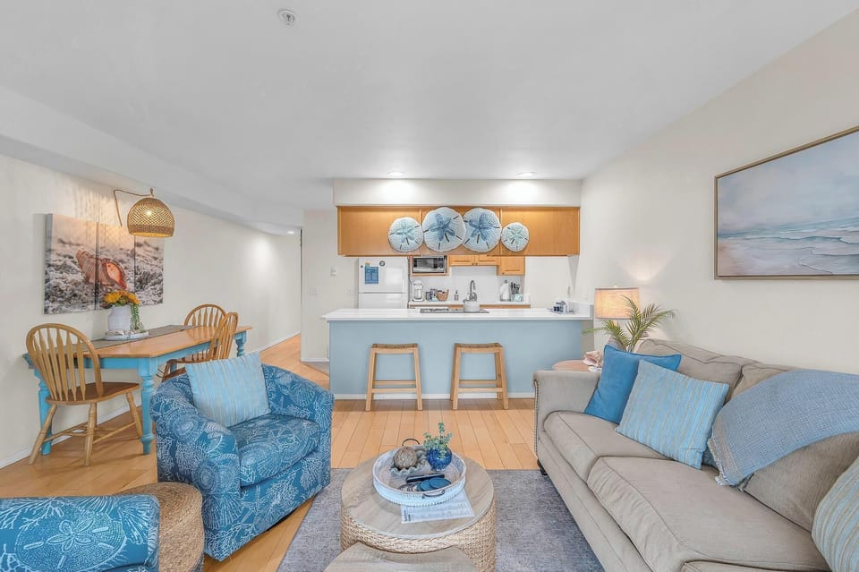 Sink into coastal comfort with ocean-inspired blues, cozy seating, and your fully equipped kitchen for memorable seaside getaways.