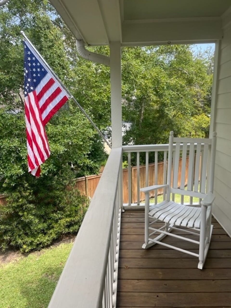 front porch has two rocking chairs and view of private driveway