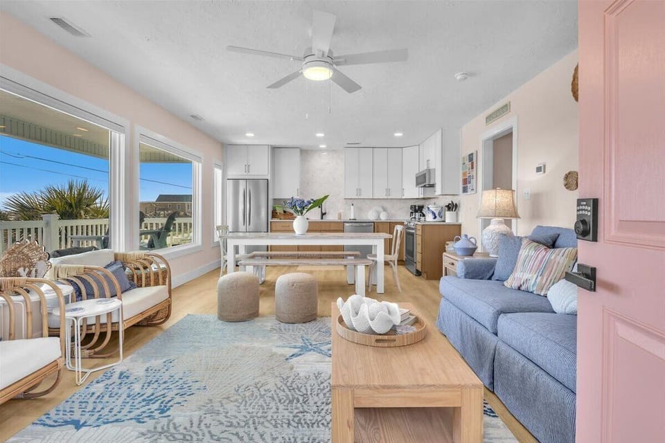 Sink into soft blue sofas in your bright, open living space where coastal charm meets modern comfort and style.
