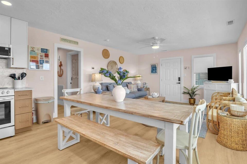 Relax in your bright, coastal-inspired open-plan living space where modern comfort meets beachy charm, perfect for gathering with loved ones.