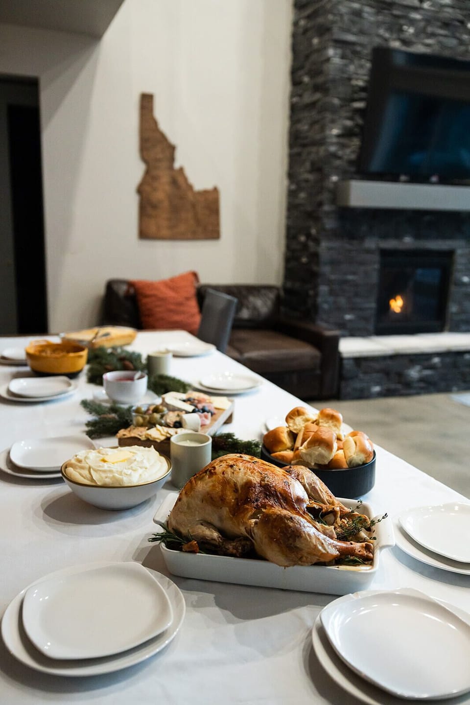 Cozy dining next to a warm stone fireplace.