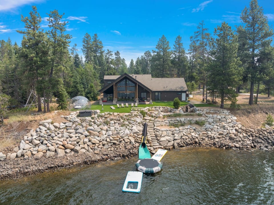 Lakeside luxury retreat with stunning forest views and private dock.