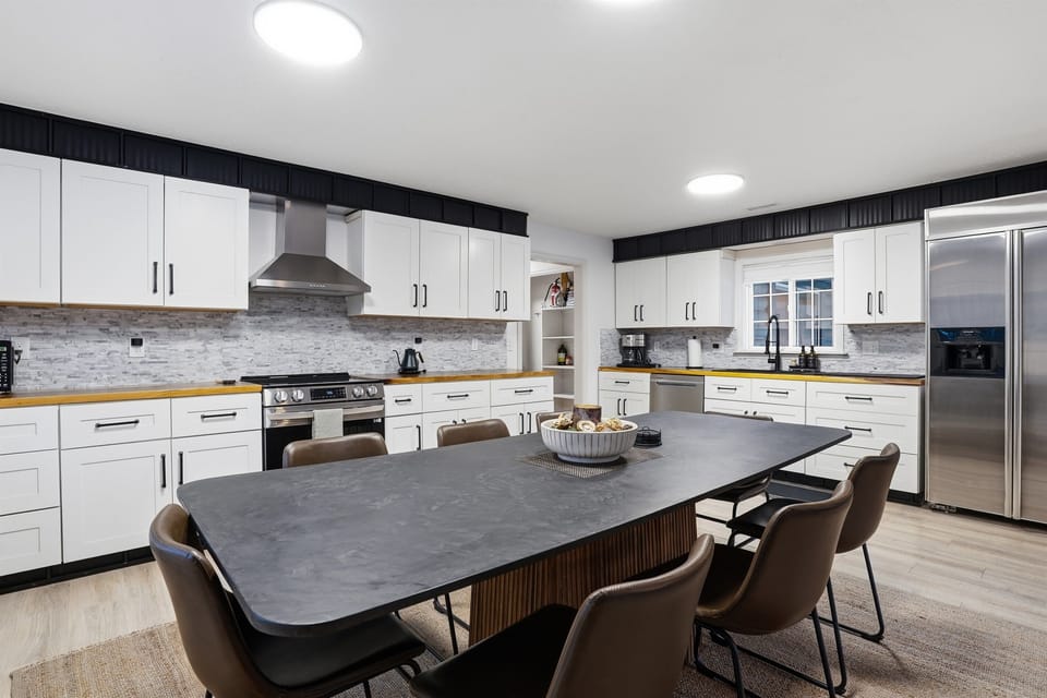 Pristine kitchen and spacious dining for groups.
