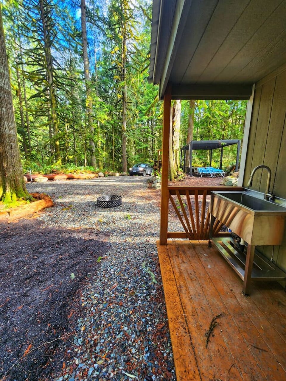 Running water next to the tent pad, soft with dirt instead of the gravel on the rest of the property.