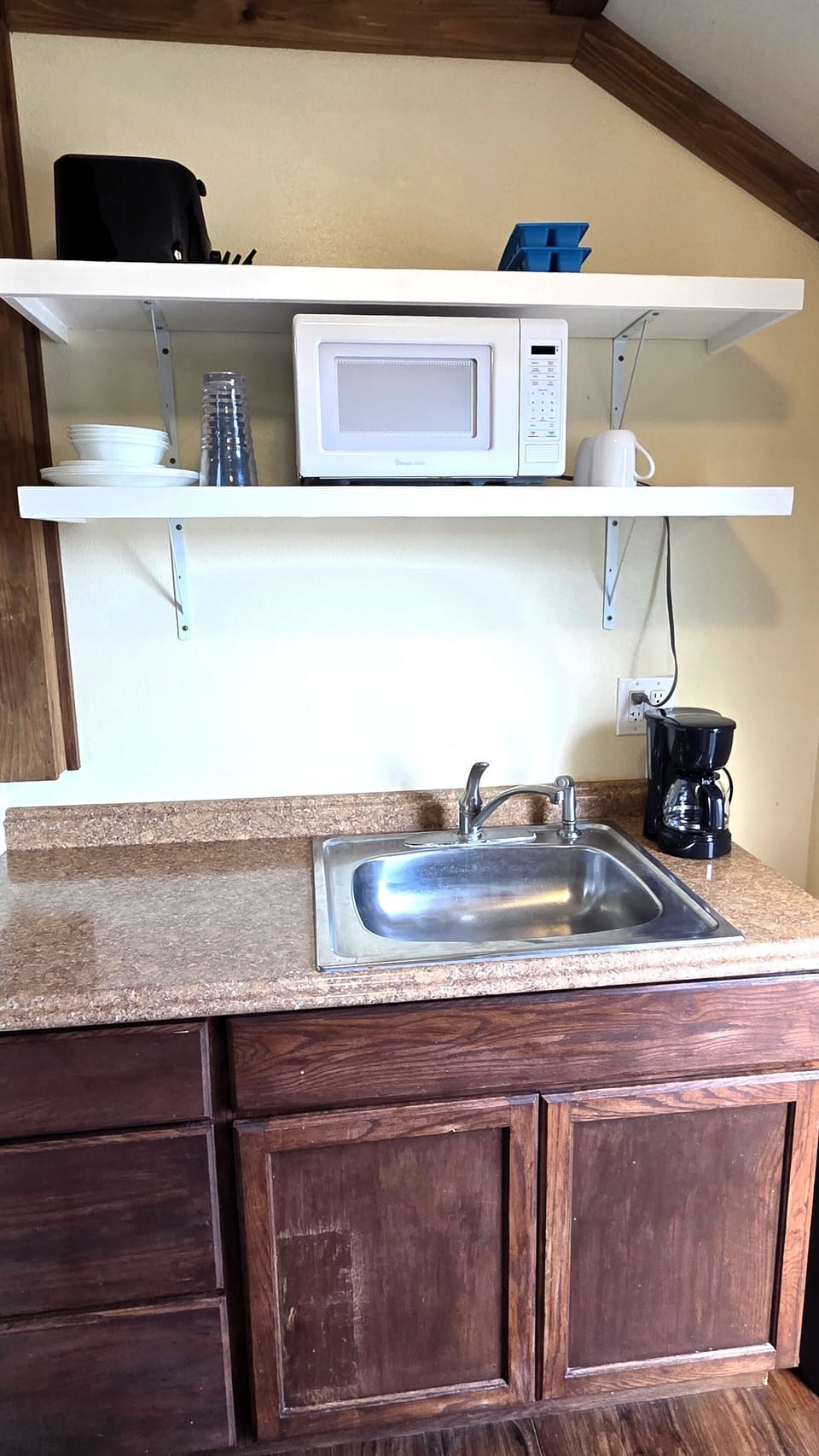 A microwave, coffee maker, and other small appliances are included