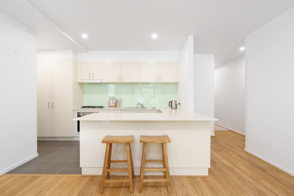 The kitchen island is perfect for casual meals, morning coffee, or planning your day while enjoying the natural light.