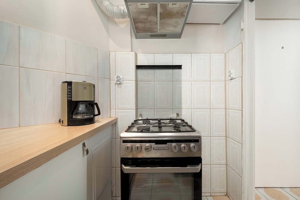 Kitchen with stove, oven, and ventilation hood.