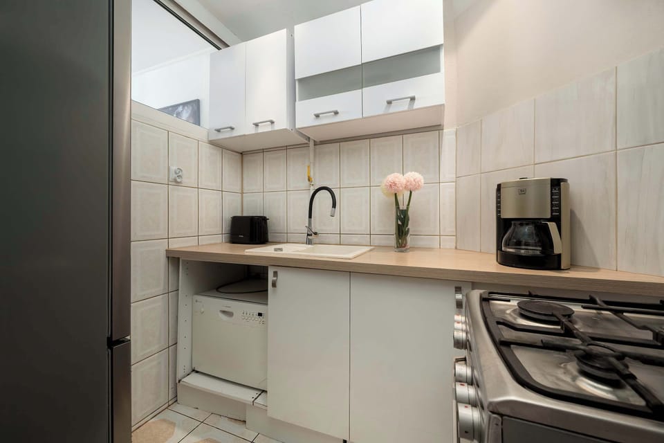 Fully equipped kitchen with wooden countertop and appliances.