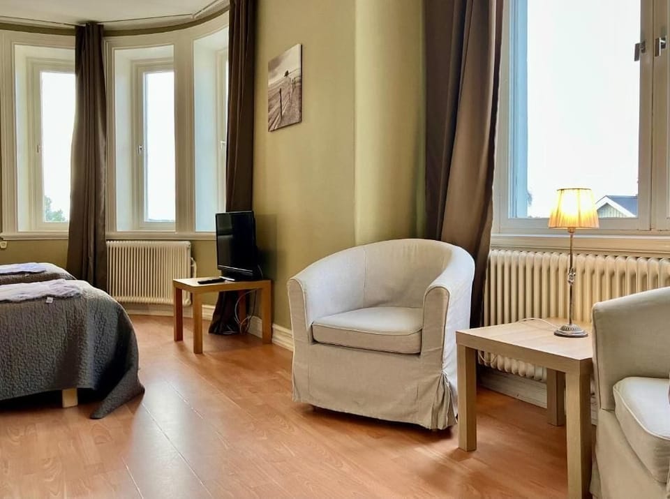 Double Room, City View | Living area | TV