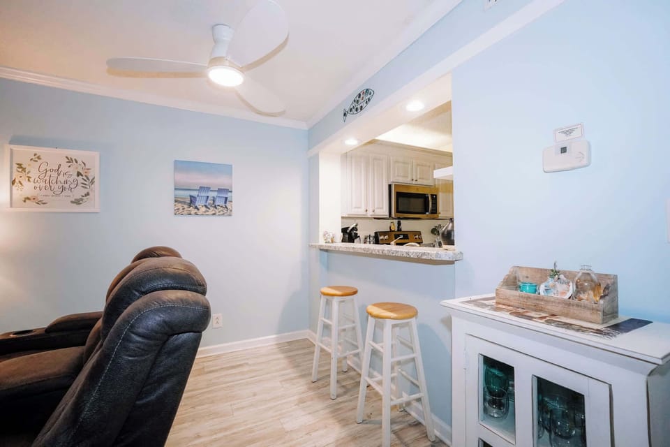 Two bar stools provide casual seating at the kitchen bar