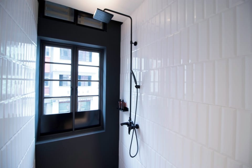 Deluxe Room, 1 King Bed | Bathroom | Shower, hair dryer, slippers, towels