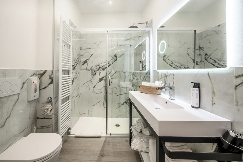 Family Triple Room, Balcony, Courtyard View | Bathroom | Shower, rainfall showerhead, free toiletries, hair dryer