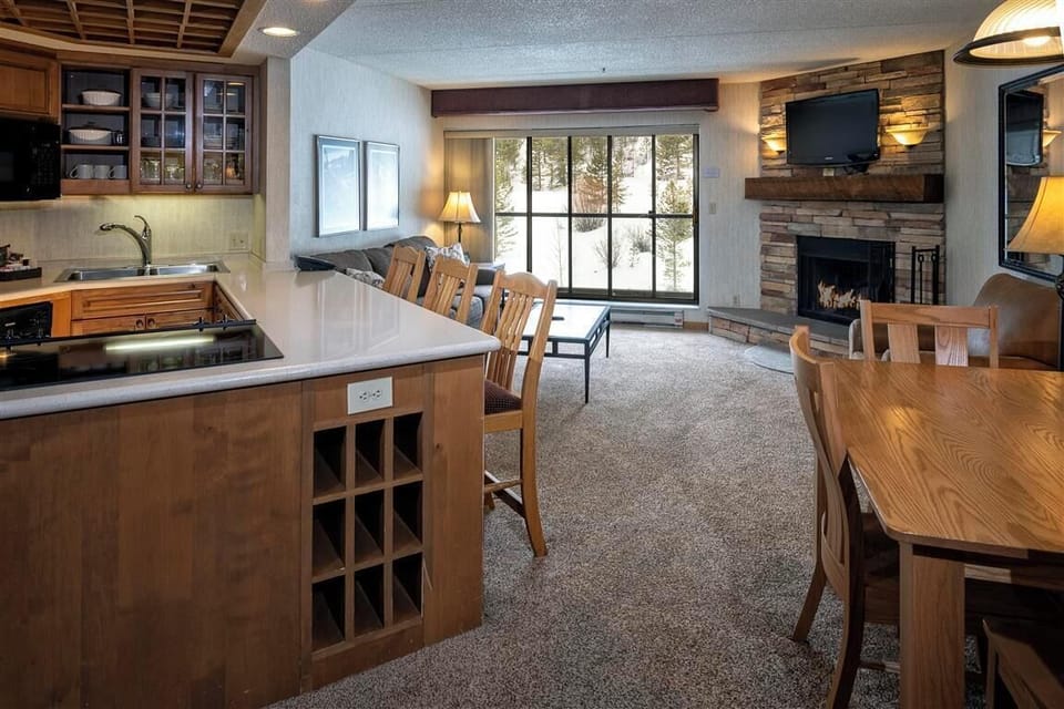 Cook and gather in the open kitchen and living space with a fireplace.