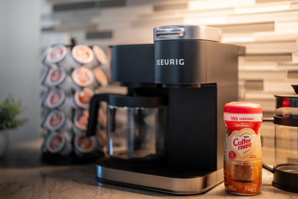 Dedicated coffee station with Keurig machine and a variety of pods for easy mornings.