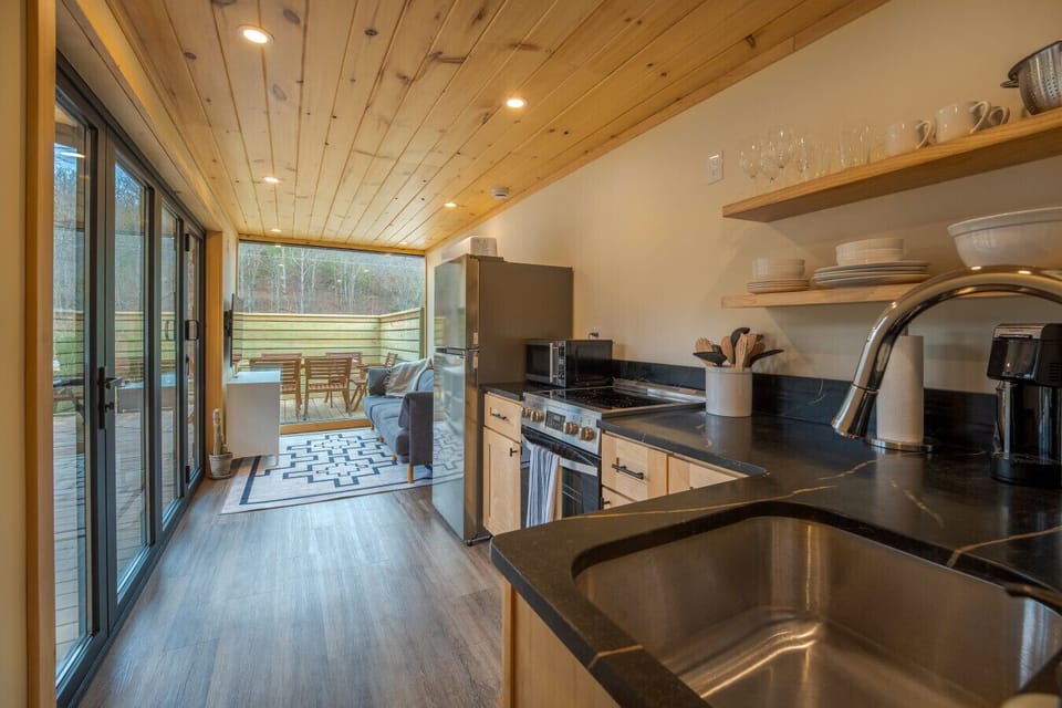 Open-concept living area connecting the kitchen and deck, designed for relaxing after a day outdoors