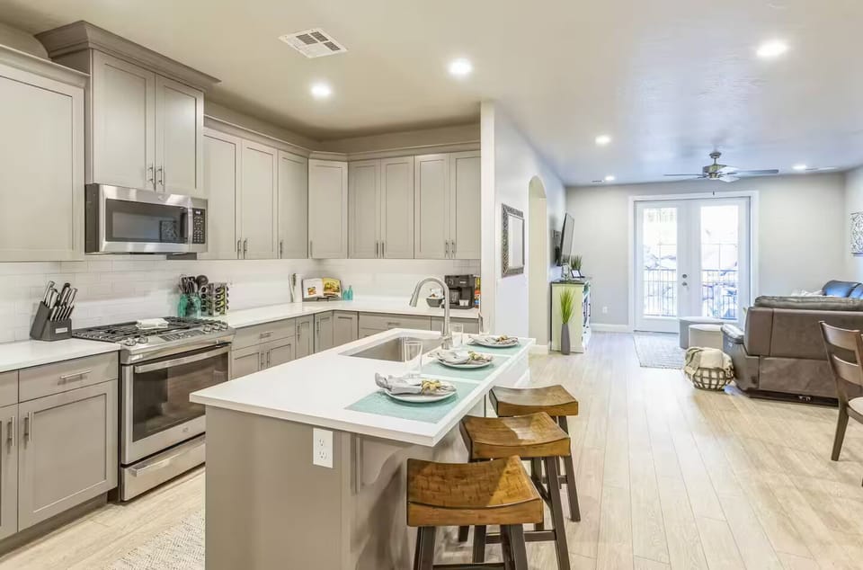 Enjoy a fully equipped kitchen with stainless steel appliances and a breakfast bar, seamlessly connecting the open main floor.