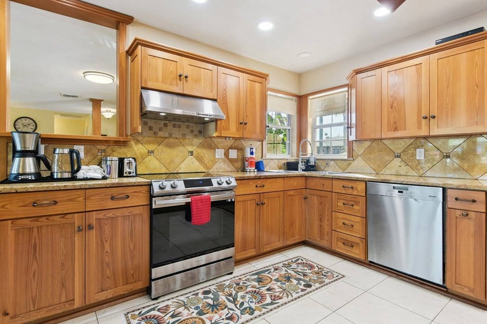 Fully Equipped Kitchen  Cook with ease in the well-appointed kitchen featuring warm wood cabinetry, stainless steel appliances.